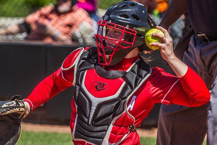 Alexis Hill throws softball during game